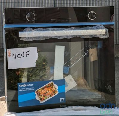 a box of food sitting on the ground in front of an oven