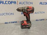 a cordless drill is sitting on a table in front of a sign