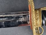 a close up of a sword with a gold handle