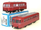 two toy trains sitting next to each other on a table