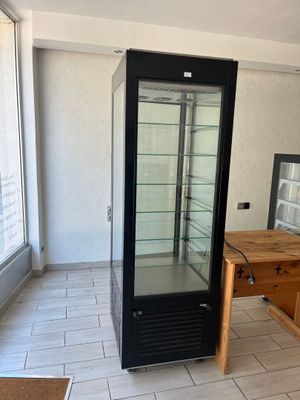 an image of a kitchen with a refrigerator and a table
