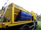 a yellow and blue truck with a blue container on the back