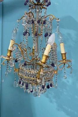 a chandelier hanging from a blue wall in a room