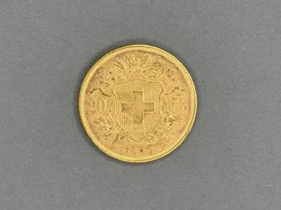 a close up of a gold coin on a gray surface