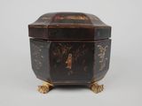 an old black and gold box with a bird on it