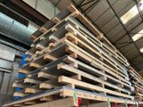a large stack of wooden pallets in a warehouse