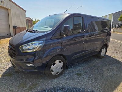 ford transit van parked in a parking lot near a building