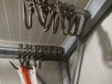 many pairs of scissors hanging from the ceiling of a garage