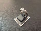a silver ring with a leaf design on top of it