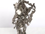 silver metal sculpture of a man with a clock on his arm