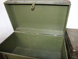 a green suitcase sitting on top of a table next to a brown suitcase