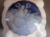 a white vase with a blue and white picture on it