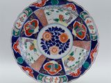 a close up of a colorful plate with flowers on it