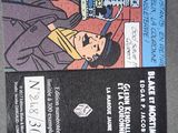 batman and catwoman comic book covers on a gray surface