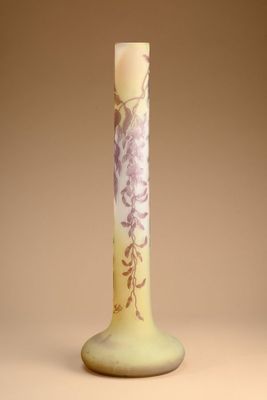 a yellow vase with purple flowers on it on a table