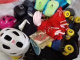 a pile of assorted skateboard gear on a bed