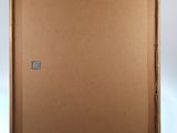 an easel with a wooden frame and a piece of cardboard on it