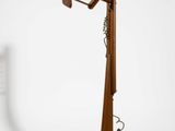a wooden floor lamp with two lamps on top of it