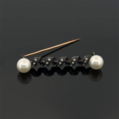 a pair of pearl and diamond hair pins