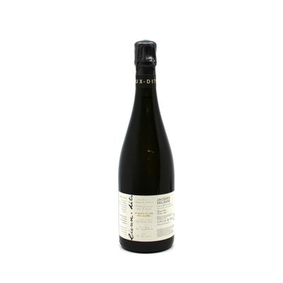 a bottle of wine sitting on top of a white table