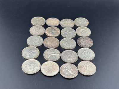 a close up of a pile of coins on a black surface