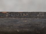 a close up of a piece of wood with writing on it