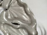 a metal sculpture of a hand holding a flower