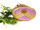 pink and gold gucci bag with gold gg logo on it