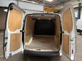 a white van with its doors open in a garage