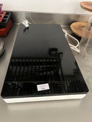 a laptop computer sitting on top of a counter