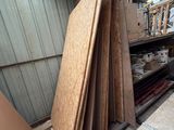 several pieces of wood are stacked on top of each other in a storage area