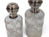 pair of antique cut glass perfume bottles with silver lids