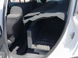 a white car with the door open and the seat down