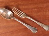 two spoons and a fork on a wooden table