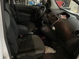 the interior of a car with the door open and the driver ' s seat down