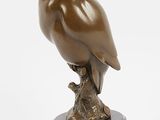 statue of an owl sitting on a branch on a white background