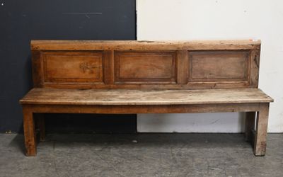 a wooden bench sitting in front of a black door