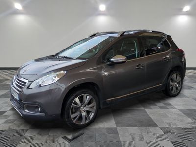 the grey car is parked in the garage on a checkered floor