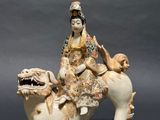 chinese figurine of a woman riding on a horse with a dog