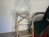 a plastic chair sitting next to a chair in a room
