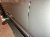 a close up of a car door with a sticker on it