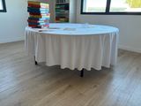 a table with a white table cloth on it in a room