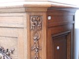 a close up of a wooden cabinet with carvings on it