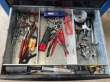 many tools in a tool box on the floor