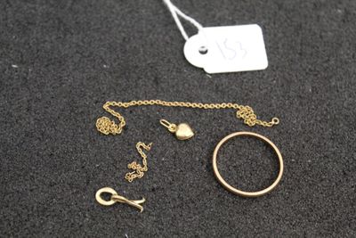 a close up of a necklace, ring, and other jewelry on a table