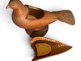 a bird that is sitting on top of a piece of wood