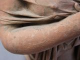 a close up of a statue of a woman holding a flower