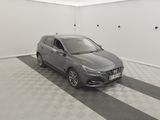 the grey car is parked in the garage on the checkered floor