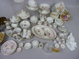 many different types of porcelain dishes and bowls on the table