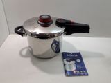 a silver pot with a red lid and a black handle